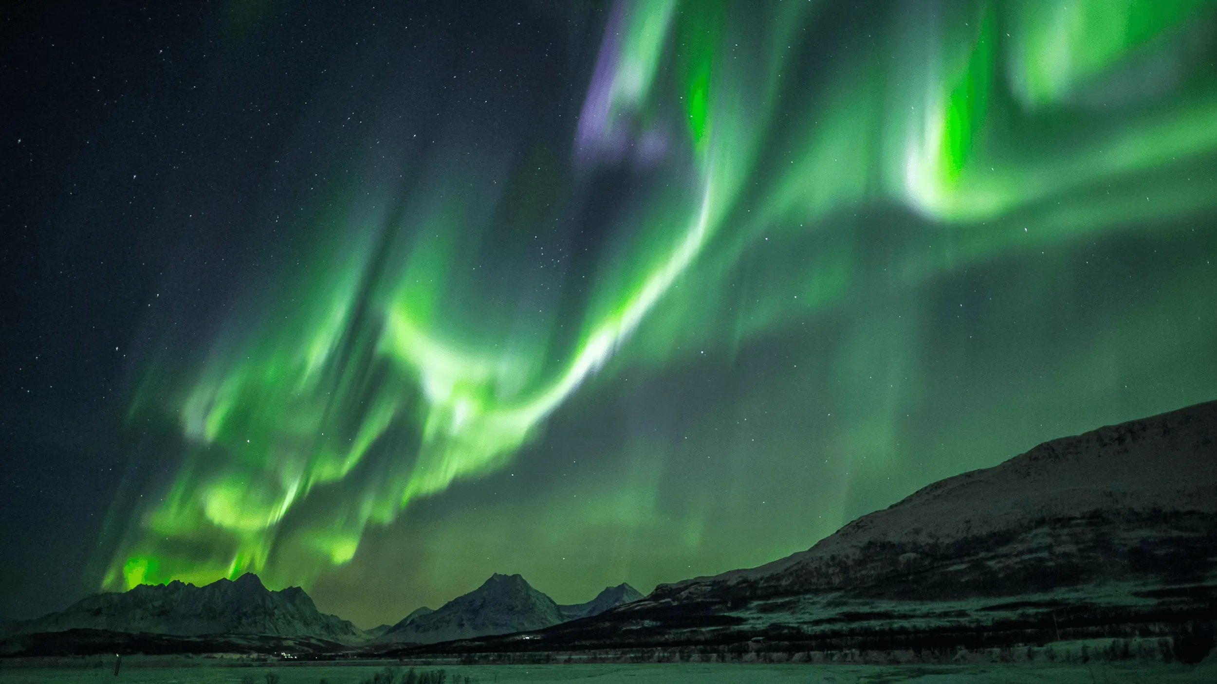 Northern lights over a Tromsø fjord